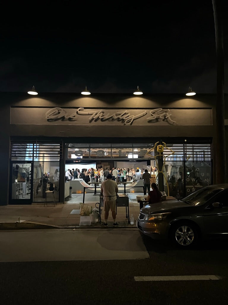 This is an image of an evening event at mnml golf club and event space, featuring a food vendor and large gathering.