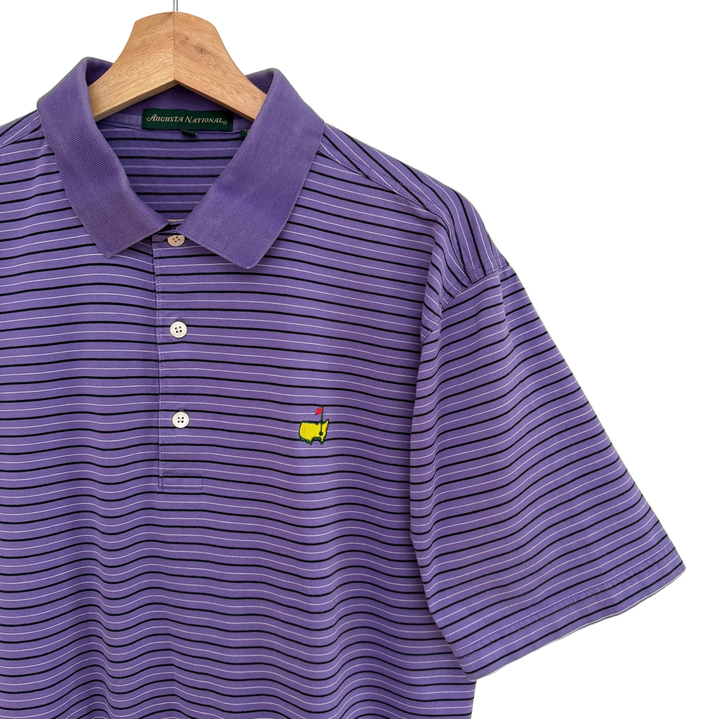 Purple striped polo shirt with a logo on a hanger against a white background