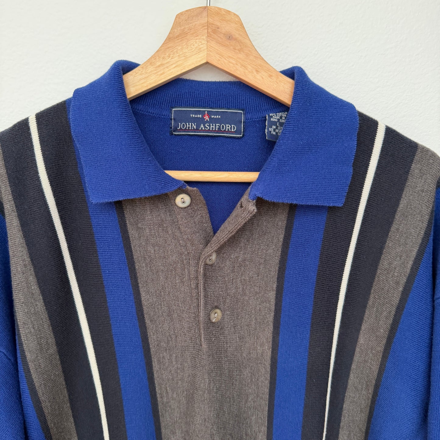 Blue and gray striped polo shirt on a hanger with John Ashford label.
