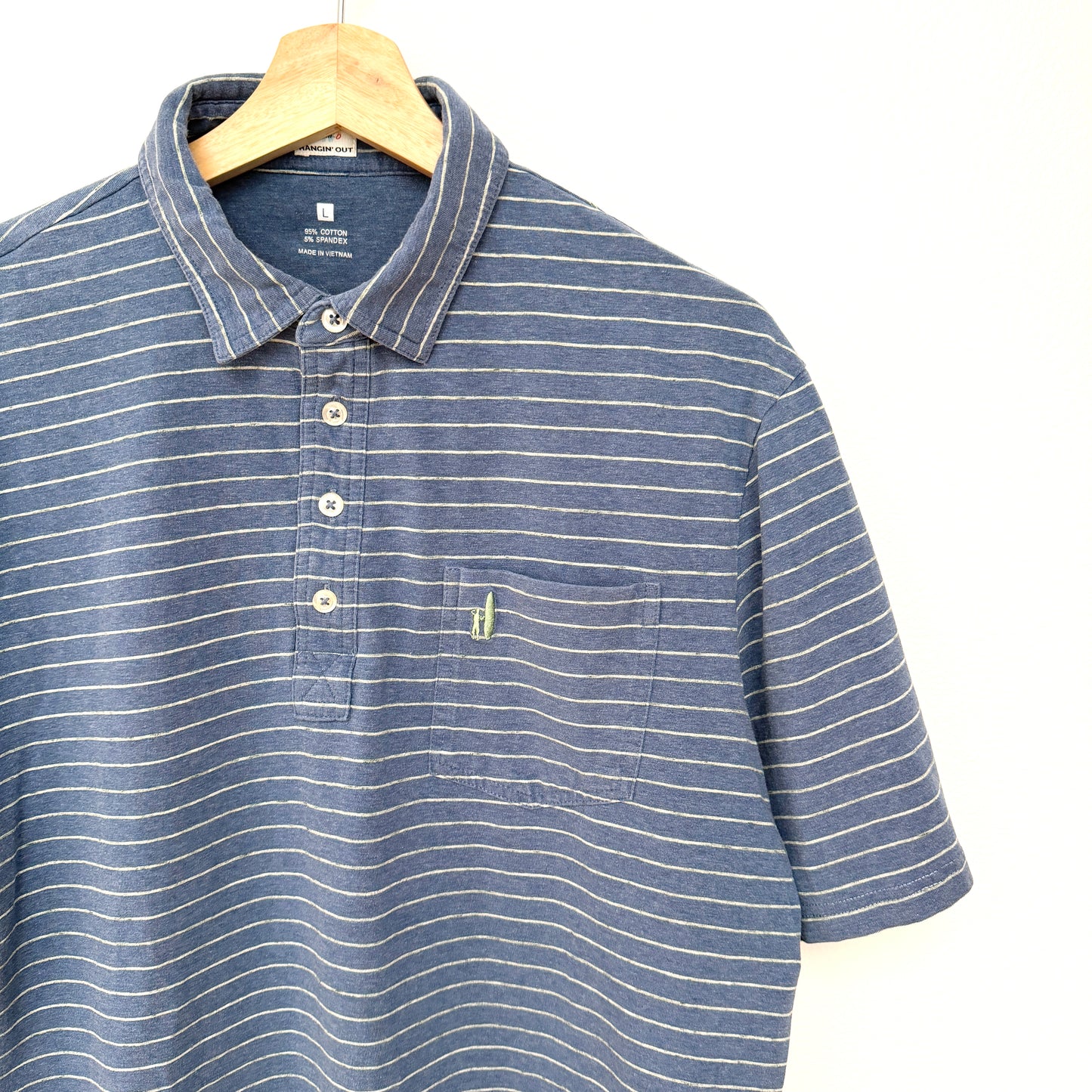 Blue striped polo shirt on a hanger against a white background