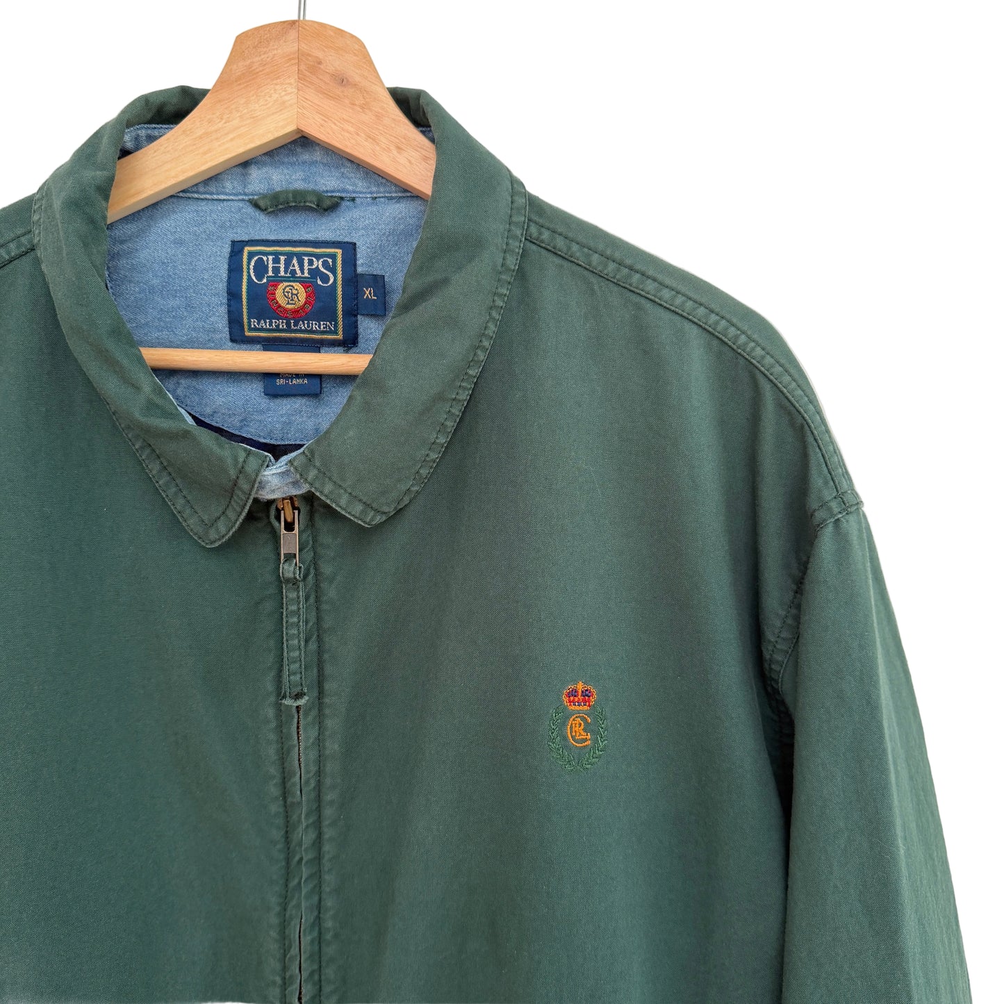 Green jacket with a logo on a hanger against a white background