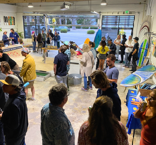 This is a photo of the MNML GOLF Club and event space interior, during a surfboard shaping show in Redondo Beach.