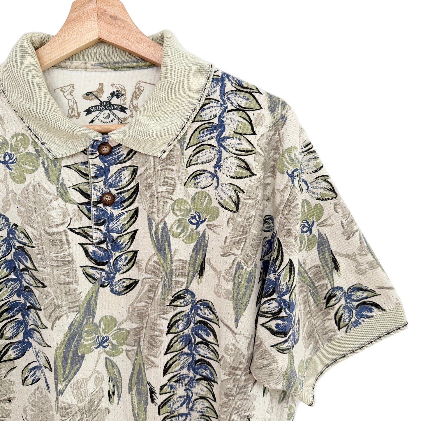 Floral patterned shirt on a hanger with a visible brand label.