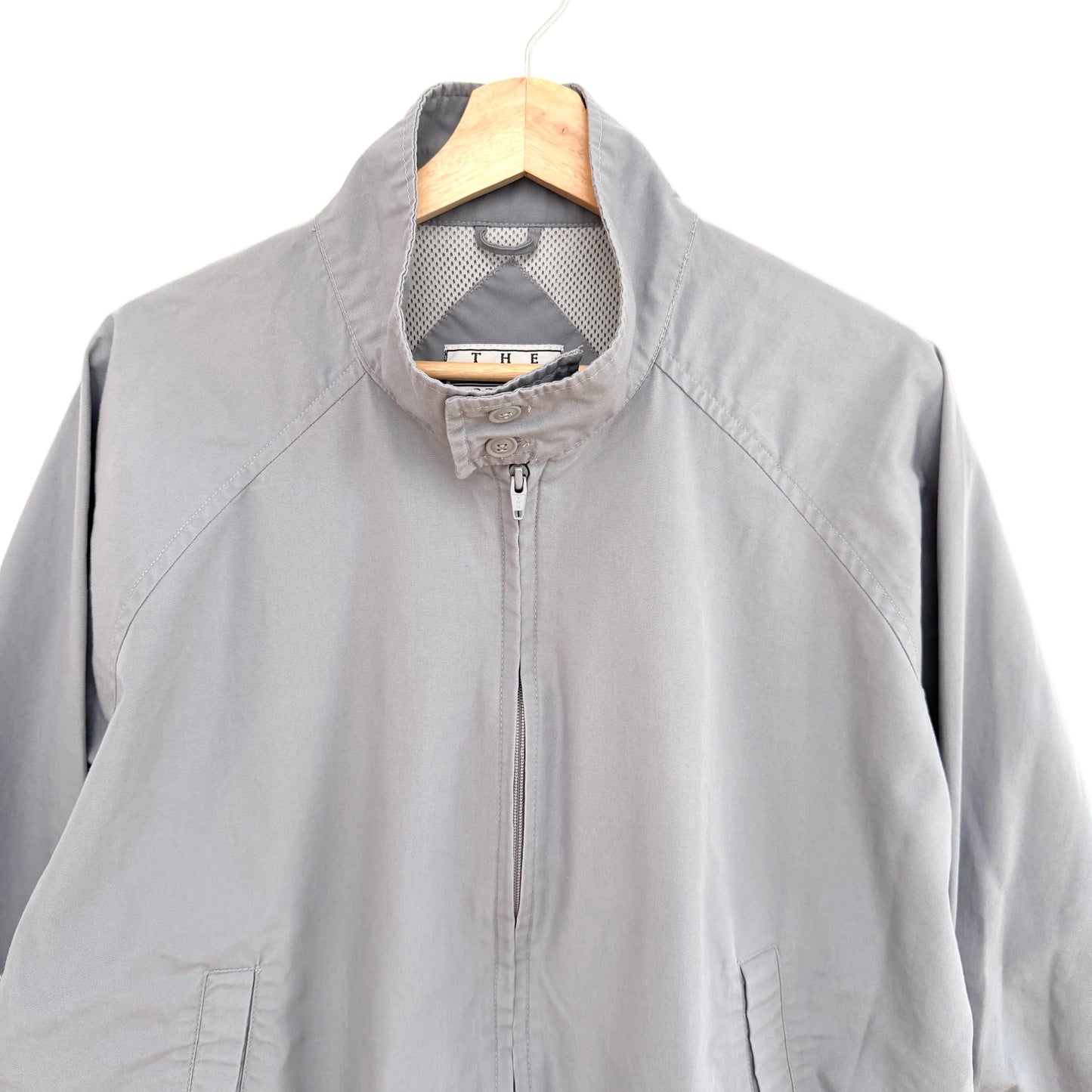 Gray jacket on a hanger against a white background