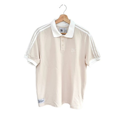 Beige polo shirt with white stripes on a hanger against a white background