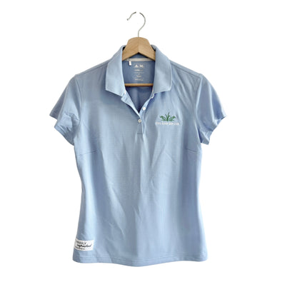 Light blue polo shirt with a logo on a hanger against a white background