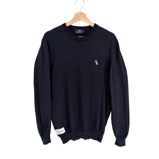 Navy sweater with a small logo on a hanger against a white background
