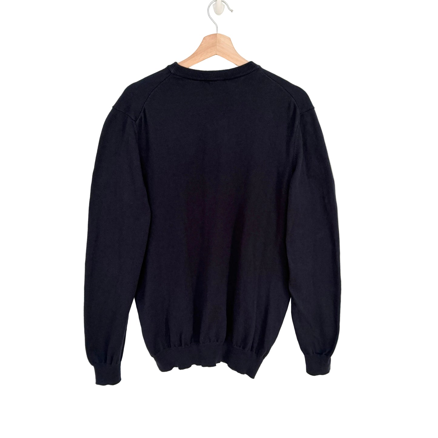 navy sweatshirt on a wooden hanger against a white background