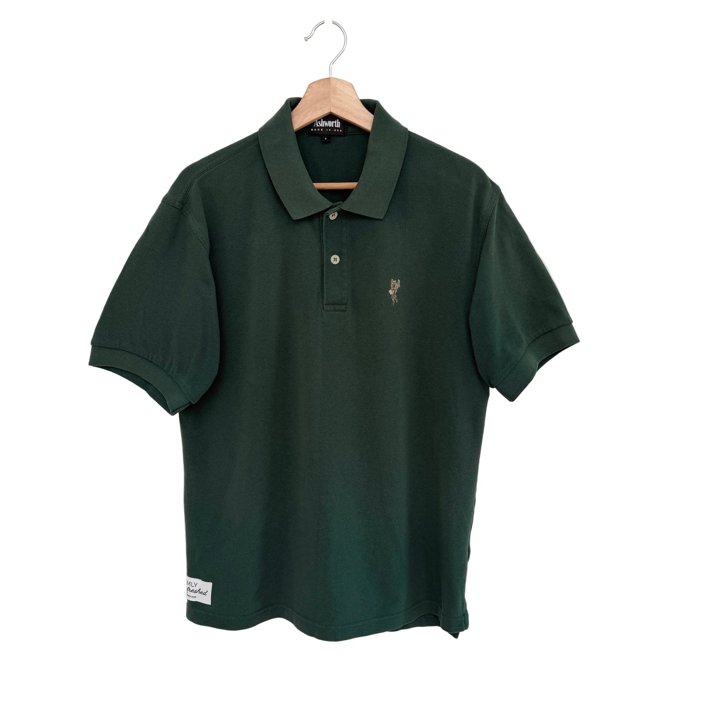 Green polo shirt with leather sleeves on a white background