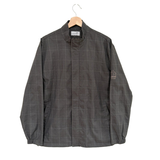 Gray checkered jacket on a hanger against a white background