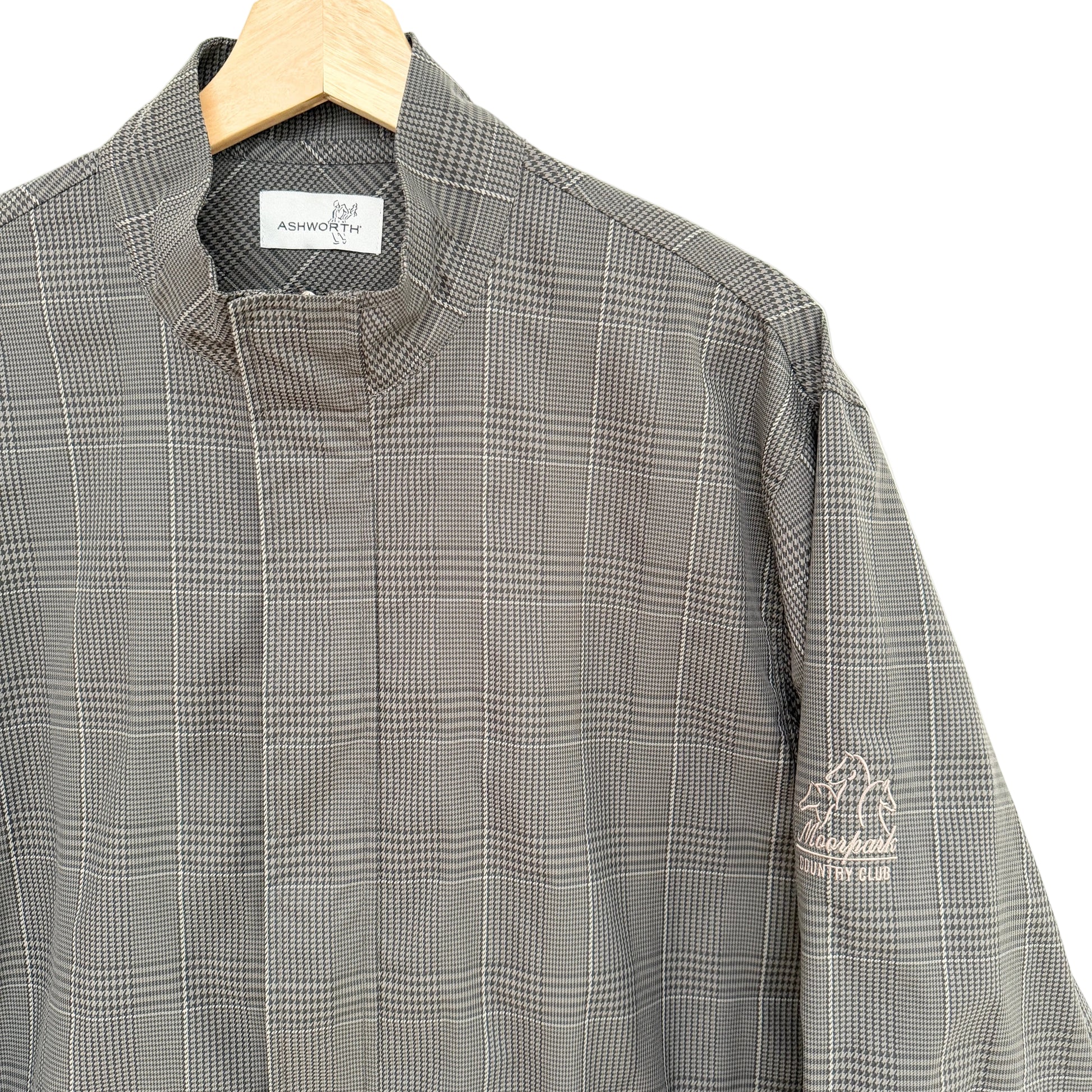 Gray checkered shirt on a hanger with a visible brand label.