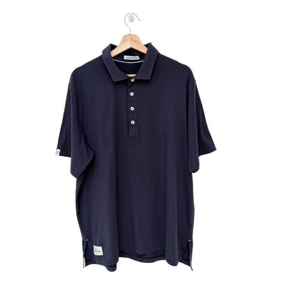 Navy blue polo shirt on a hanger against a white background