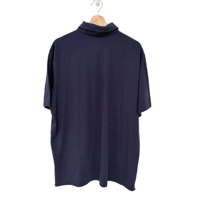 Navy blue turtleneck shirt on a hanger against a white background