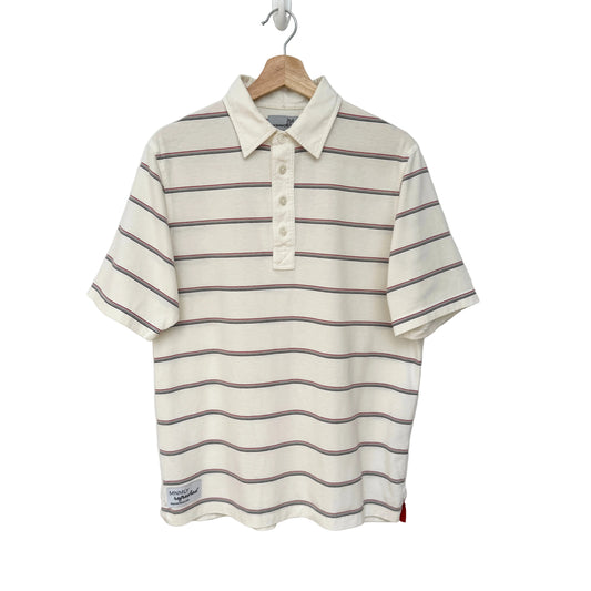 Striped polo shirt on a hanger against a white background