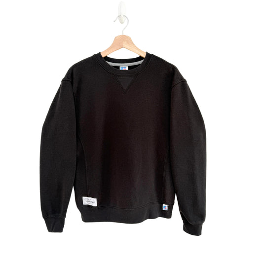 Black sweatshirt on a hanger against a white background