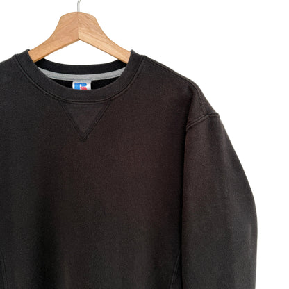 Black sweatshirt on a hanger with a white background