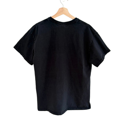 Black t-shirt on a wooden hanger against a white background