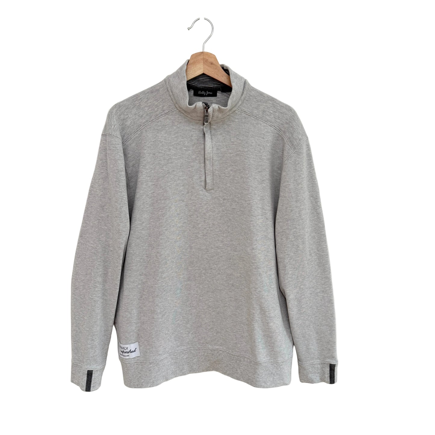 Gray long-sleeve shirt on a hanger against a white background