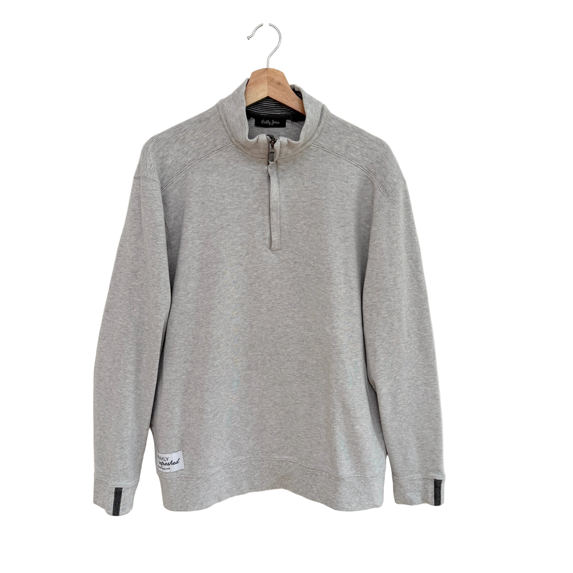 Gray long-sleeve shirt on a hanger against a white background