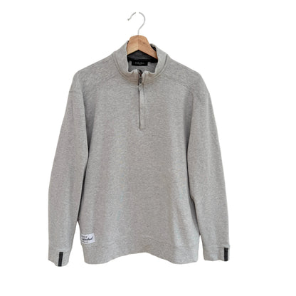 Gray long-sleeve shirt on a hanger against a white background