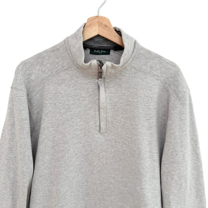 Gray pullover with a quarter zip on a hanger against a white background