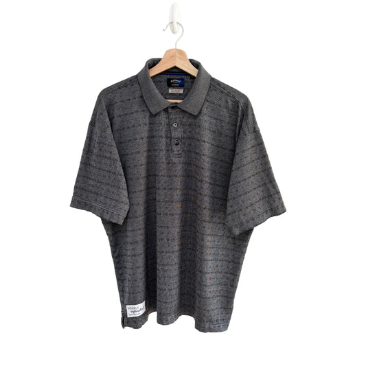 Gray patterned polo shirt on a hanger against a white background