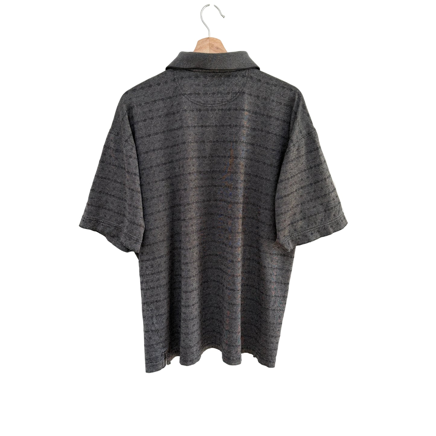 Gray textured shirt on a hanger against a white background