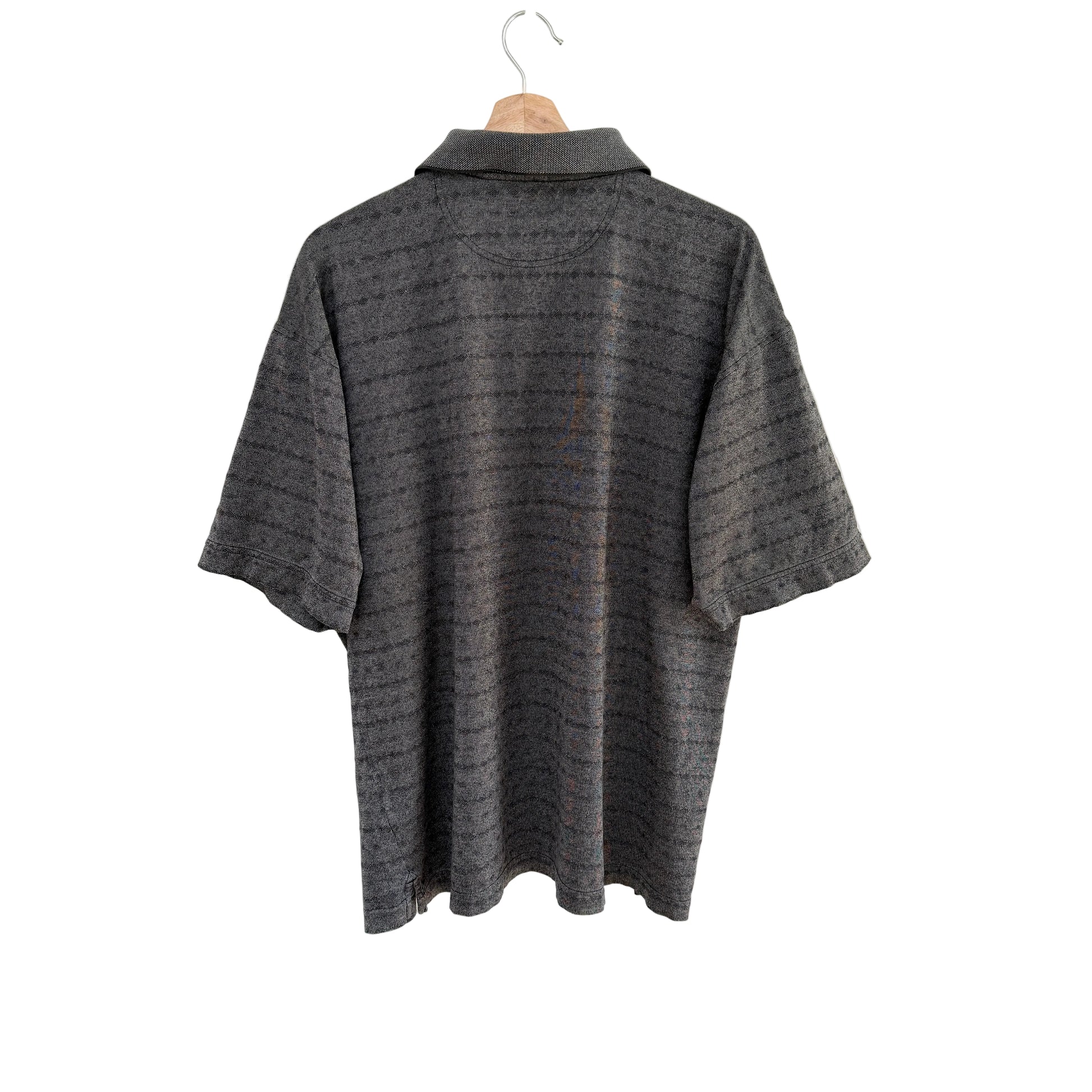 Gray textured shirt on a hanger against a white background