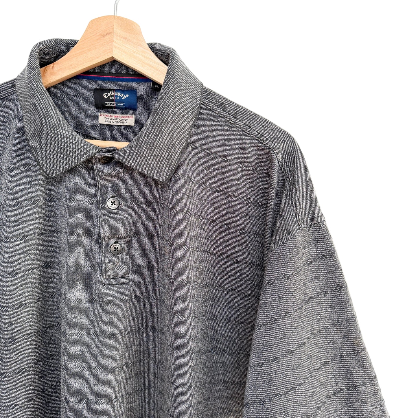 Gray polo shirt on a hanger with a white background