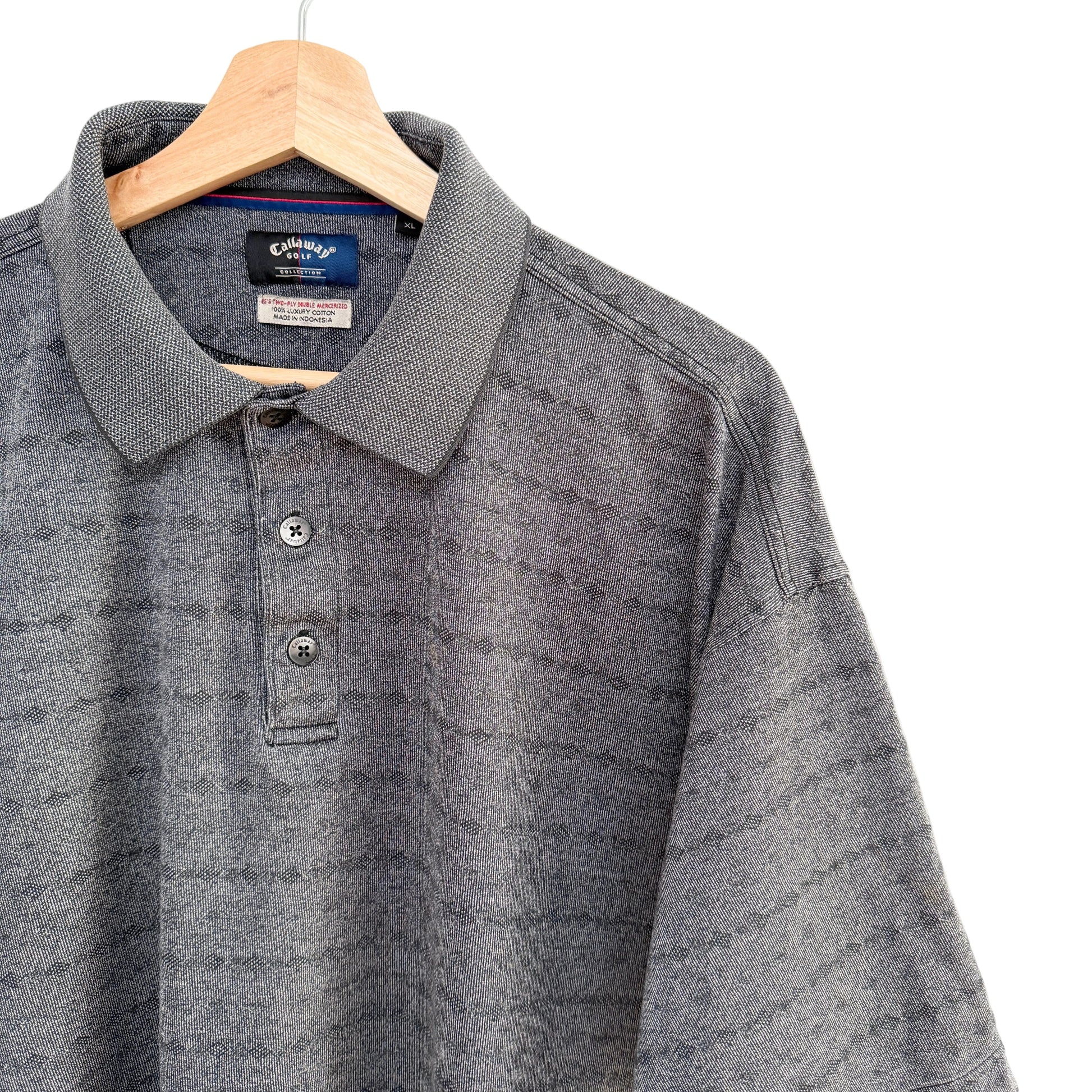 Gray polo shirt on a hanger with a white background