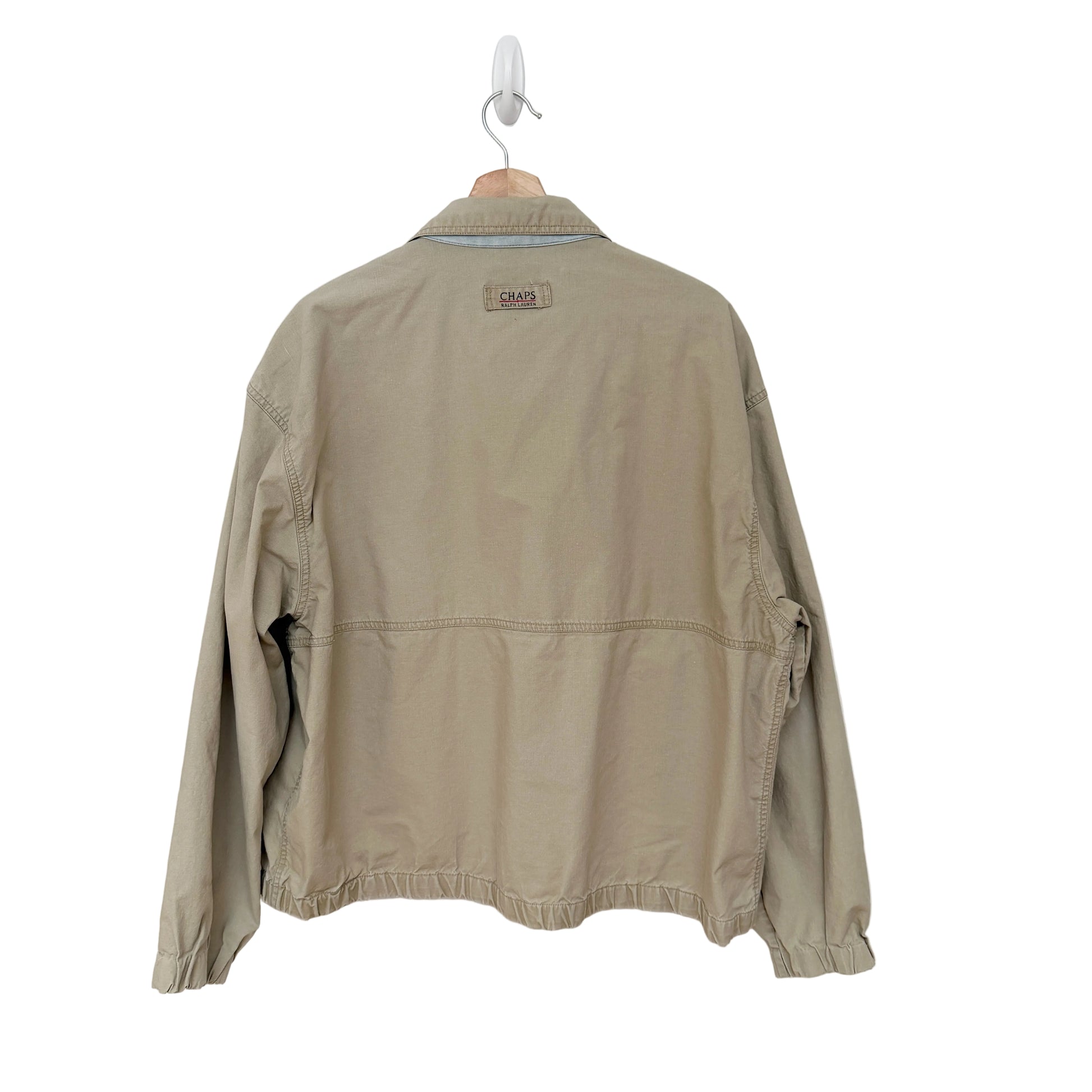 Beige jacket on a hanger against a white background