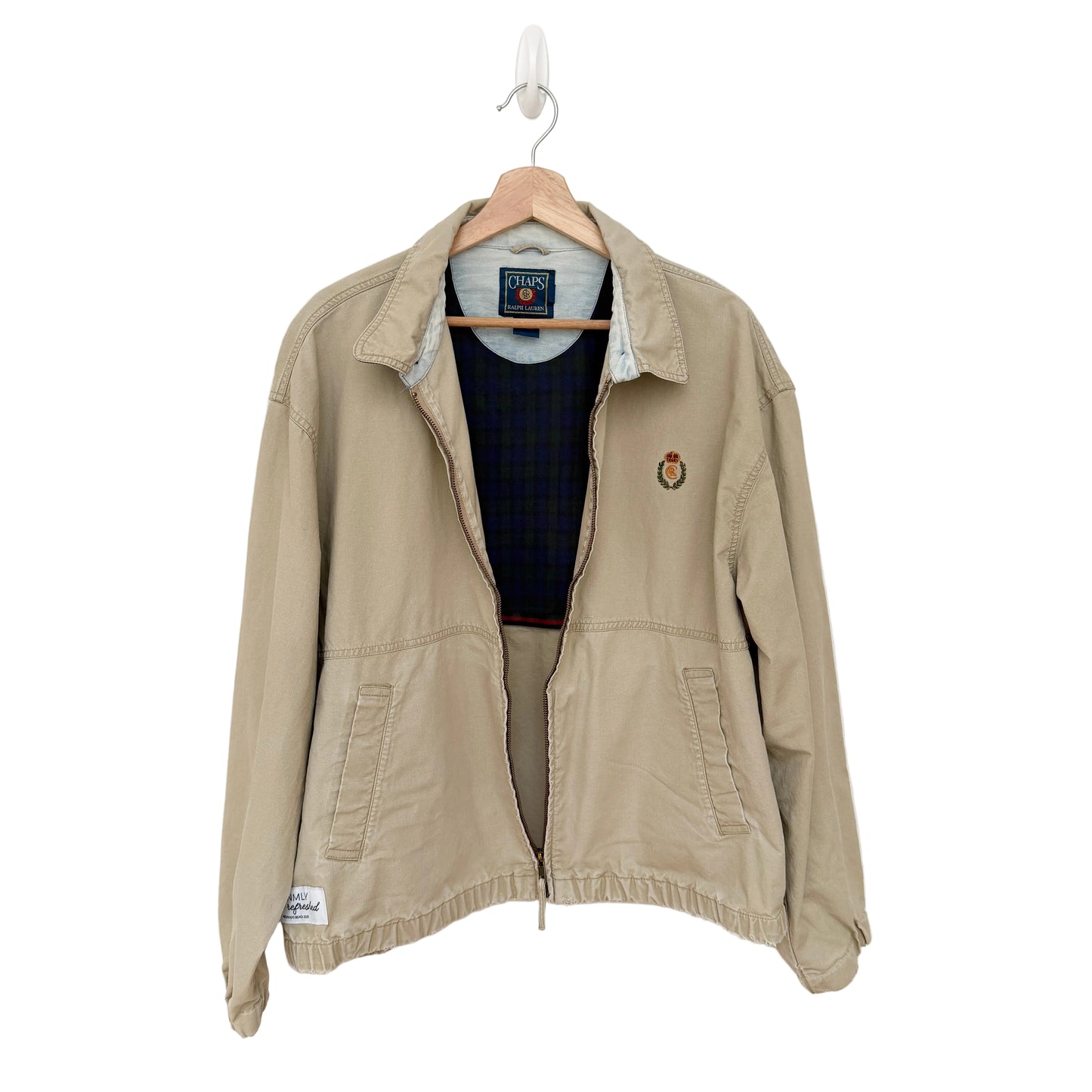 Beige jacket on a hanger against a white background