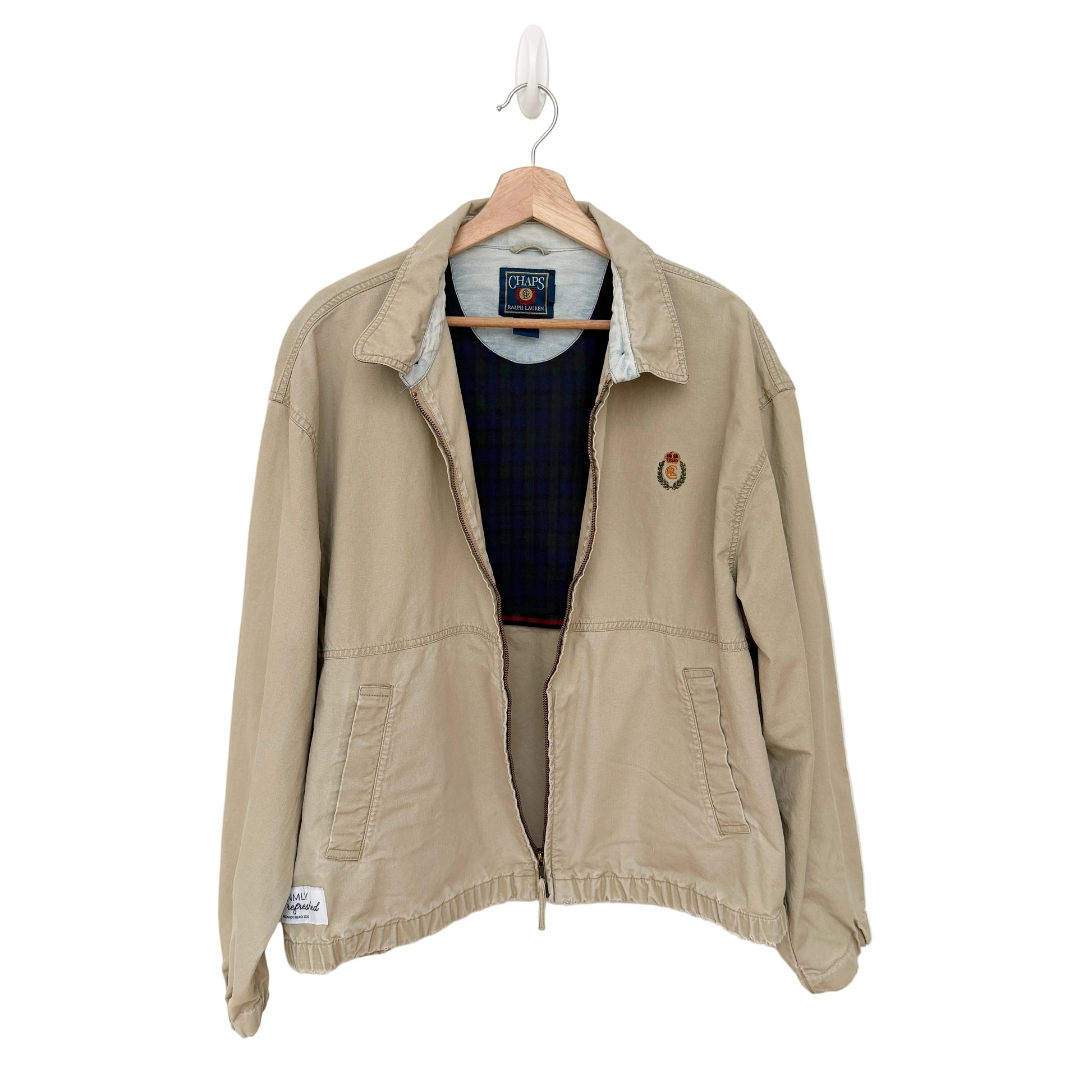 Beige jacket on a hanger against a white background