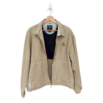 Beige jacket on a hanger against a white background