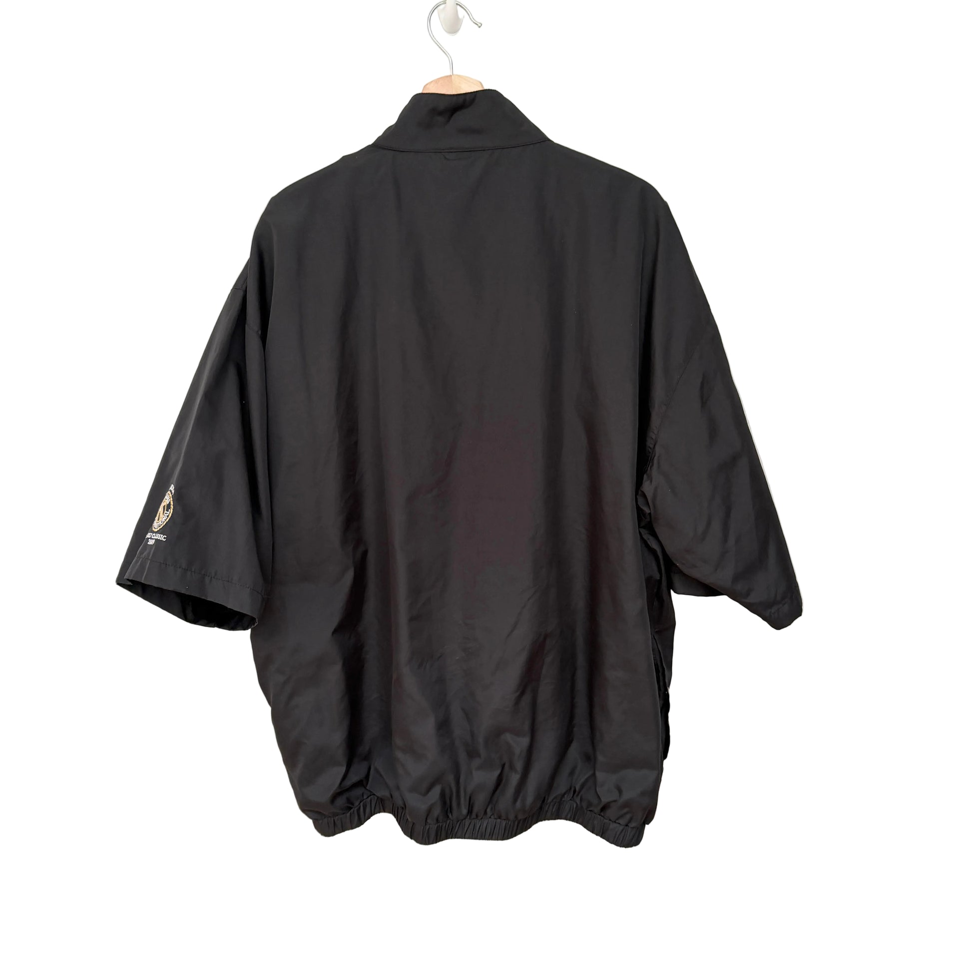 Black jacket on a hanger against a white background