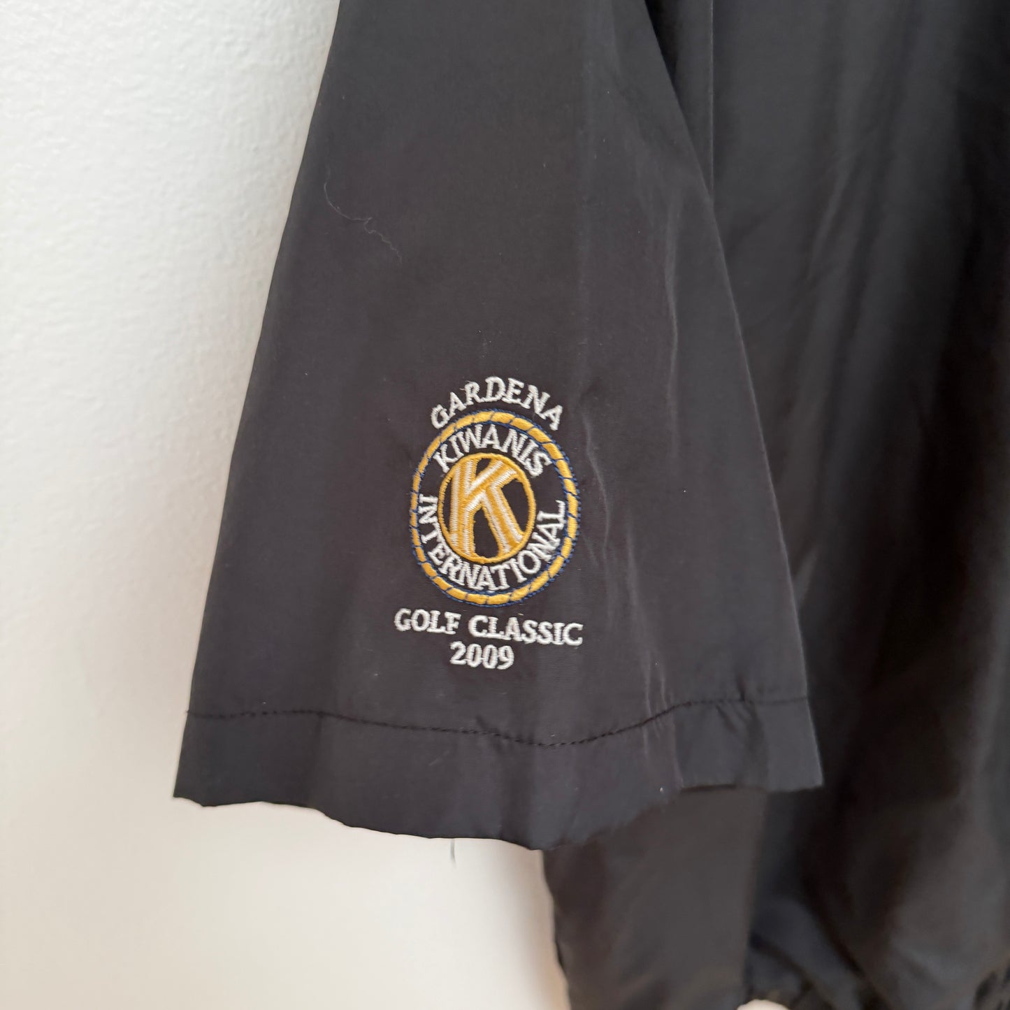 Black jacket with embroidered Kiwanis International logo on a white background