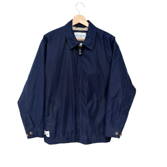 Navy jacket on a hanger against a white background