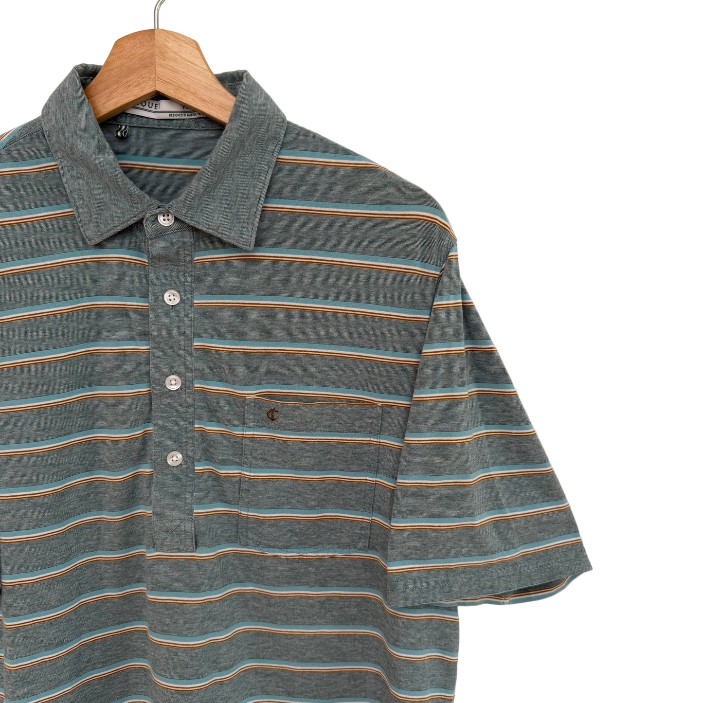 Striped polo shirt on a wooden hanger against a plain background
