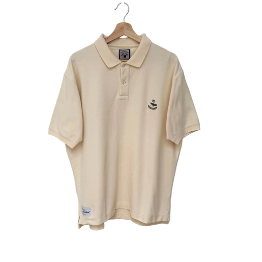 Beige polo shirt with a logo on a hanger against a gray background