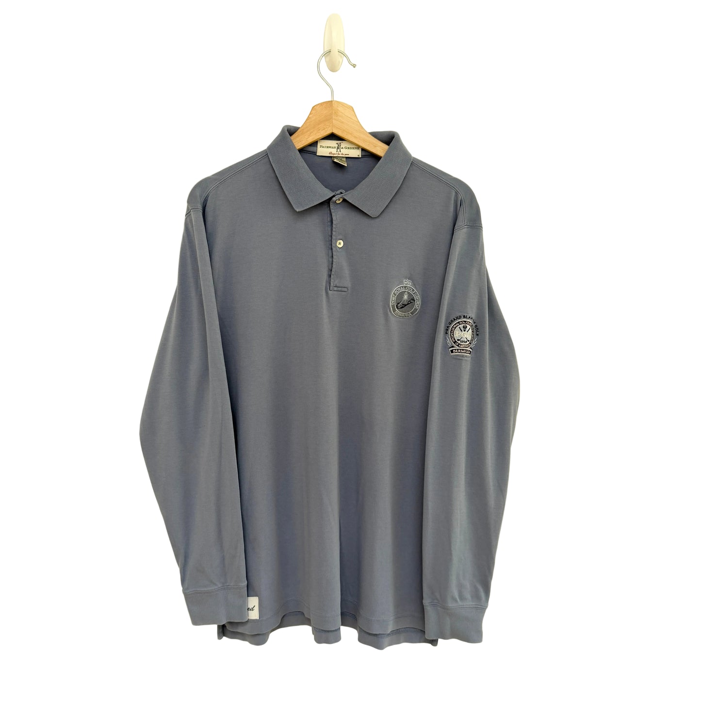 Slate blue long-sleeve polo shirt with logos on a beige background