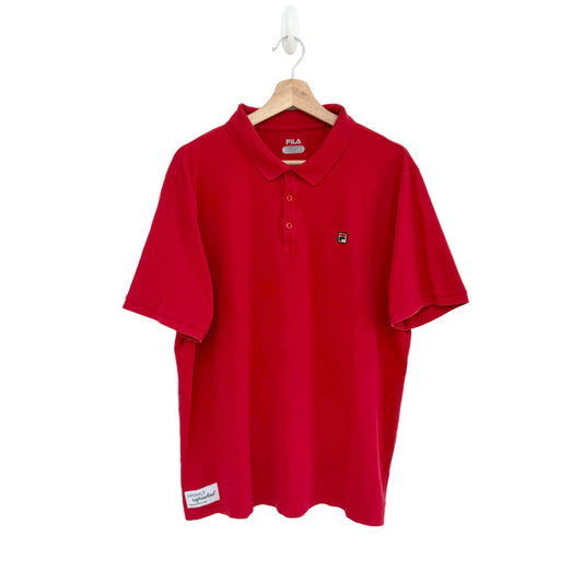 Red polo shirt on a hanger against a white background