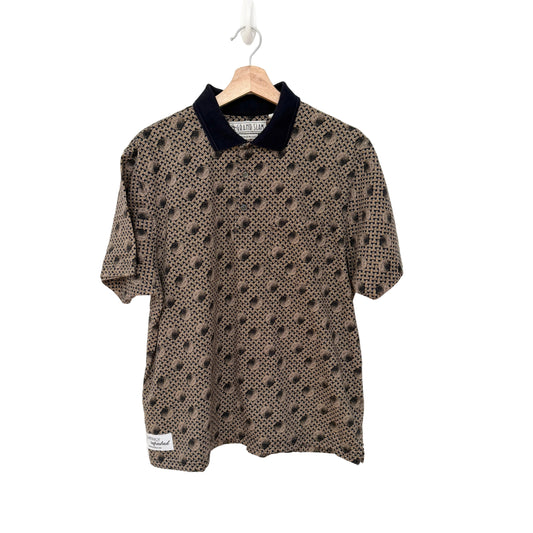 Short-sleeve shirt with black pattern on a hanger against a white background