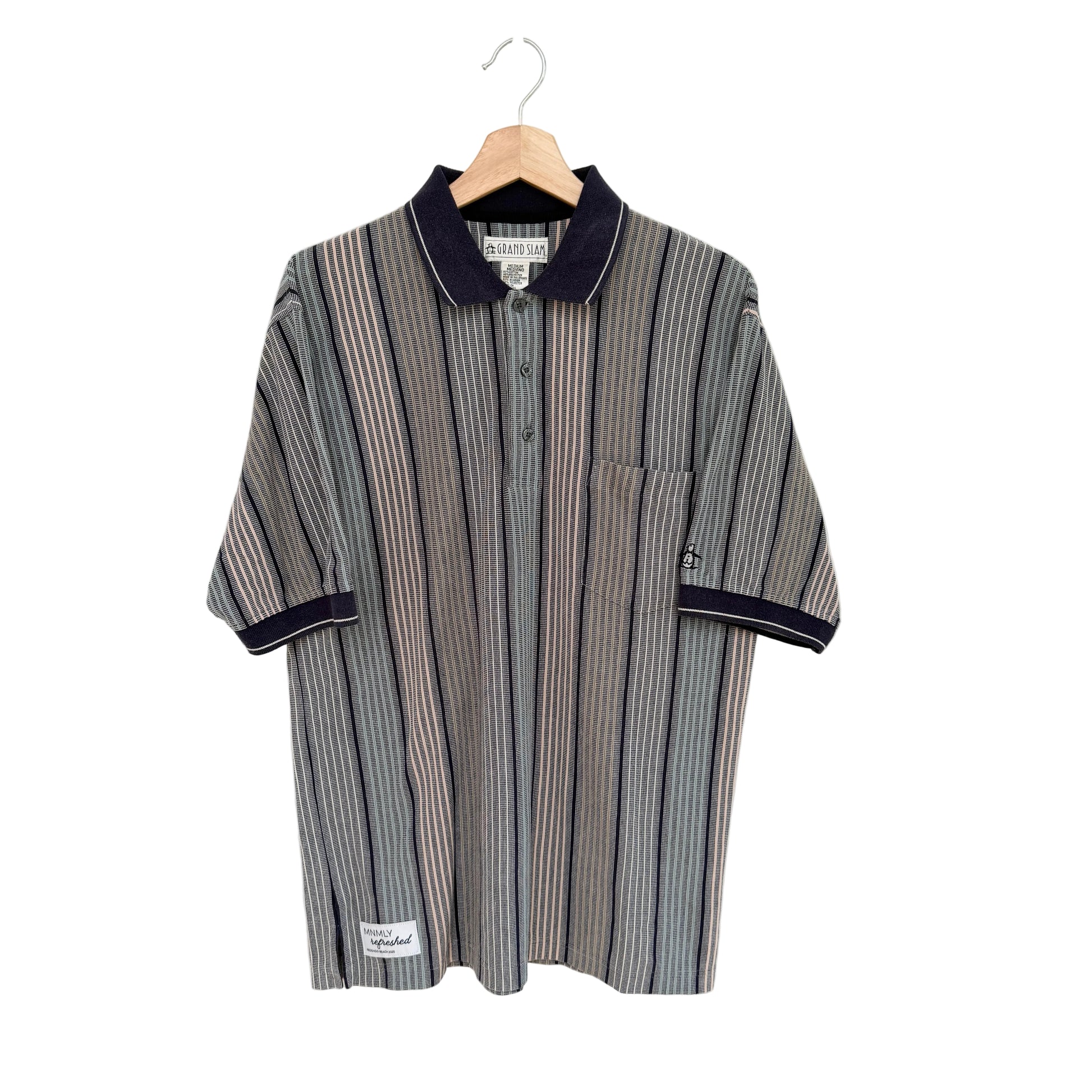 Striped shirt with navy trim on a hanger against a white background