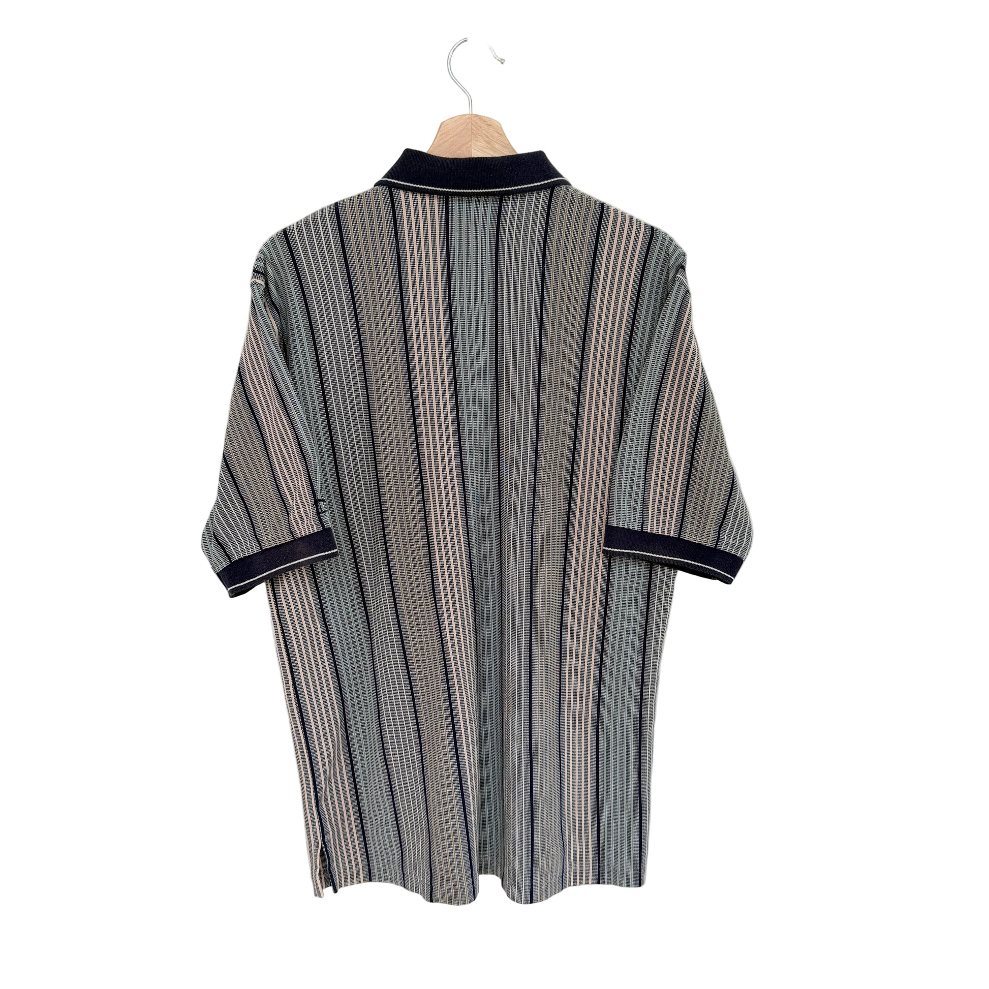 Striped shirt with navy trim on a hanger against a white background