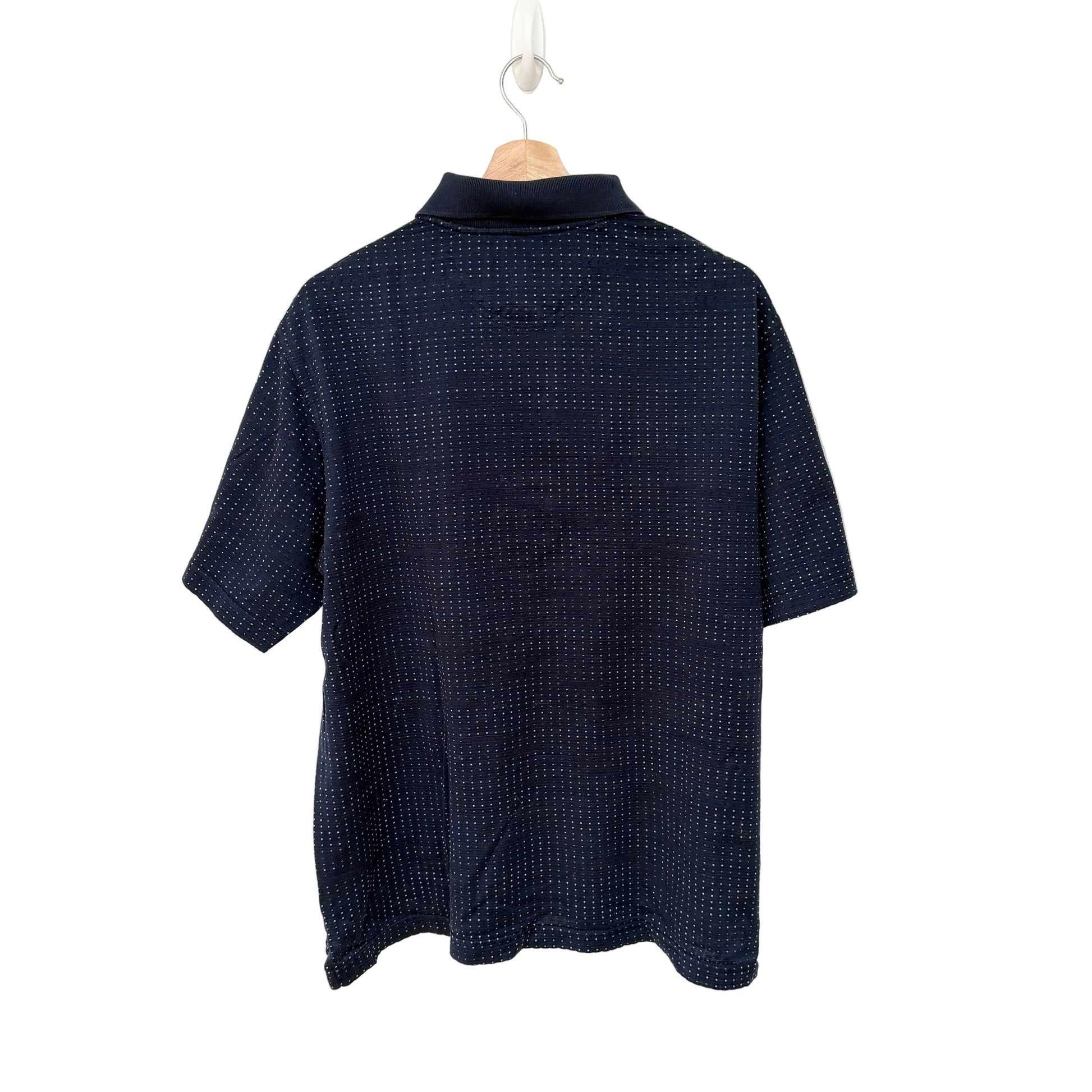 Navy blue textured shirt on a hanger against a white background