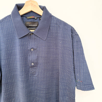 Blue patterned polo shirt on a hanger with a white background