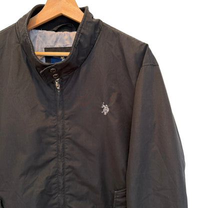 A black zip-up jacket with a small white embroidered U.S.