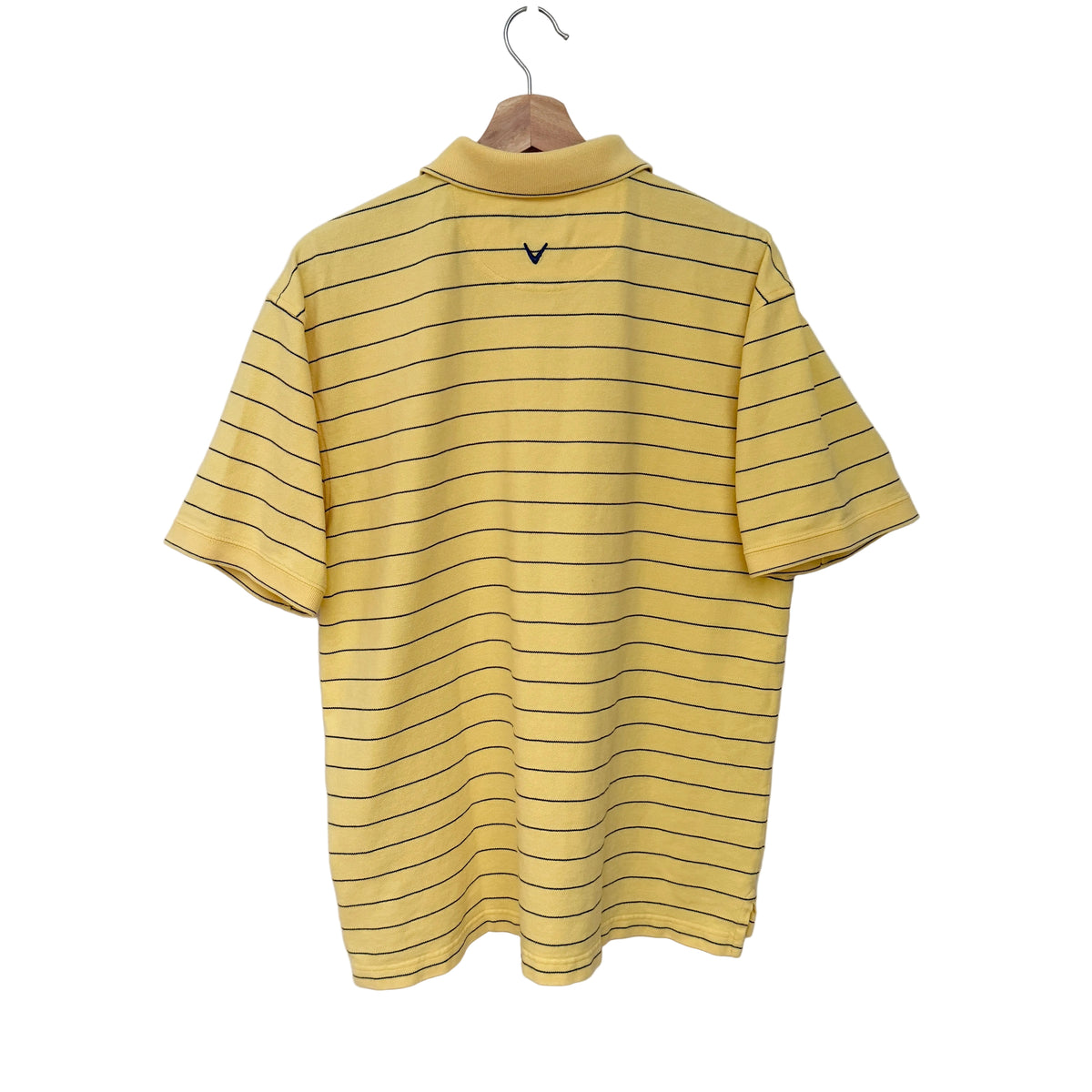 A yellow short-sleeve polo shirt with thin black horizontal stripes, hanging on a wooden hanger against a plain white wall. A small black V-neck logo is visible on the upper back.