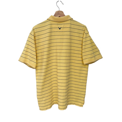 A yellow short-sleeve polo shirt with thin black horizontal stripes, hanging on a wooden hanger against a plain white wall. A small black V-neck logo is visible on the upper back.
