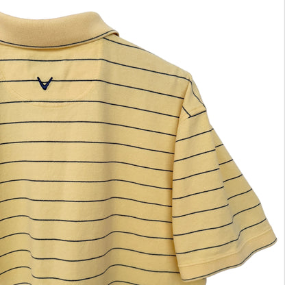 A yellow short-sleeve polo shirt with thin black horizontal stripes, hanging on a wooden hanger against a white wall. A small black V-neck logo is visible on the upper chest.